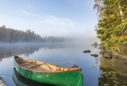 Green canoe sitting on the lake in Ontario